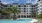 Pet-Friendly Luxury Apartments in Maitland, FL - Aventon Gem Lakes - Pool with Palm Trees and Lounge Chairs